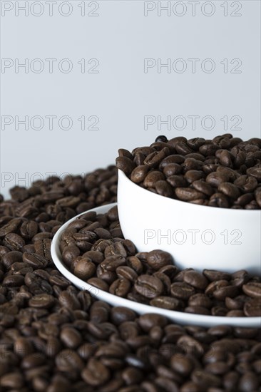 A cup of coffee on coffee beans