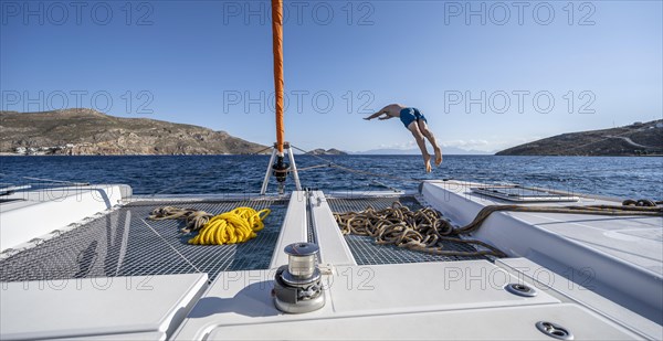 Young man jumps into the water