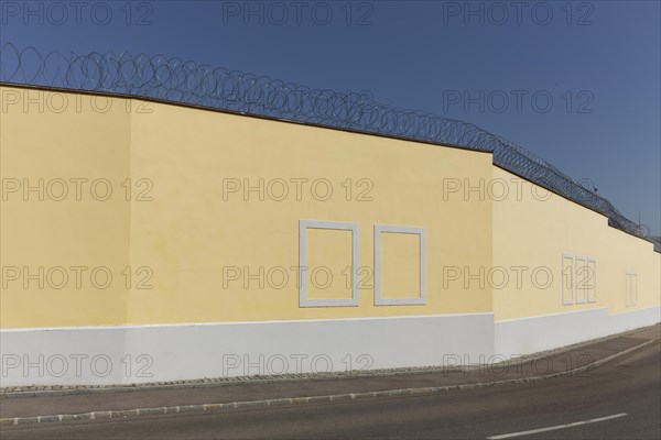 Prison wall with painted window frames