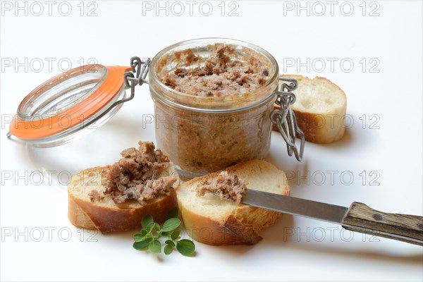 A jar of meat terrine and slices of bread