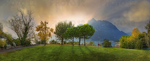 Breathtaking sunset on Lake Garda with hiker