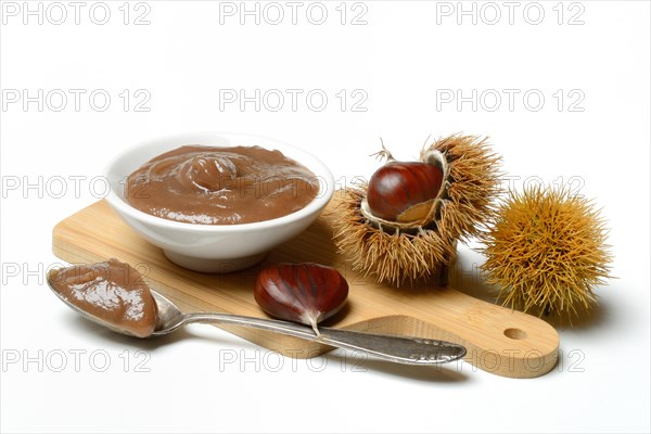Chestnut cream in bowl on wooden board