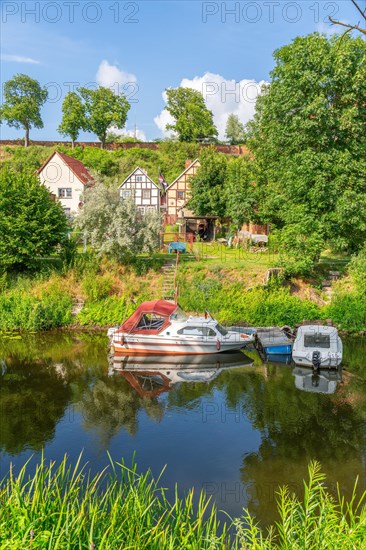View across the moat to half-timbered houses