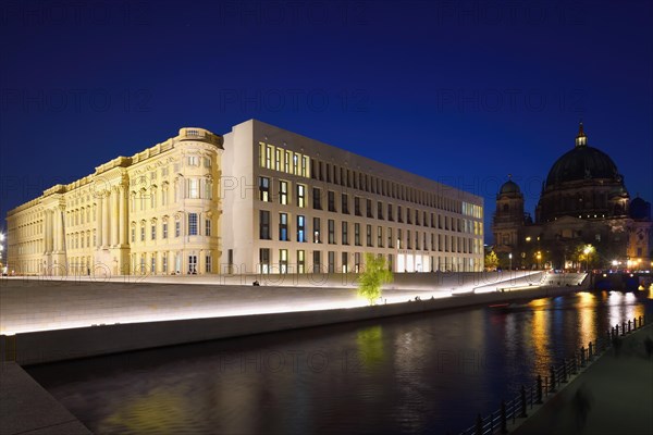 The Berlin Palace or Humboldt Forum along the Spree river and the Berliner Dom illuminated at night