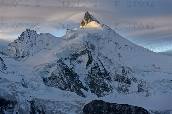 Sunset at the summit of Zinalrothorn