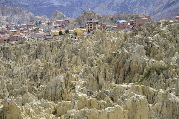 Residential houses behind the bizarre rock formations in Valle de la Luna