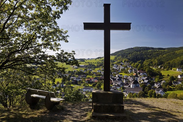 Cross of the Kreuzberg Chapel with a view of the Duedinghausen district of the town of Medebach