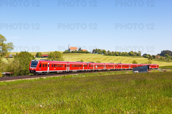 Bombardier Transportation RegioSwinger tilting technology regional train of Deutsche Bahn DB with church St. Alban in Allgaeu Bavaria in Aitrang