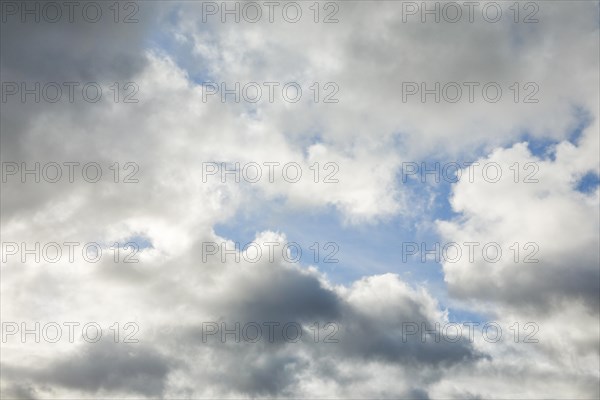 Stratocumulus clouds and blue sky windows form spectacular cloud formation in the sky during Foehn storm