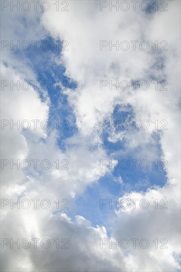 Stratocumulus clouds and blue sky windows form spectacular cloud formation in the sky during Foehn storm