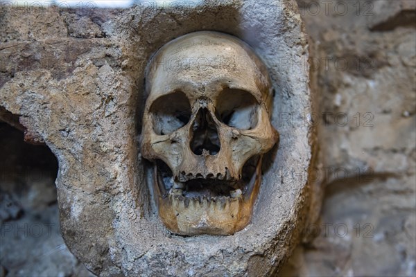 Stone structure embedded with human skulls