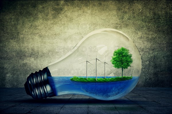 Light bulb as a micro planet with blue water and a island with green grass and tree growing inside
