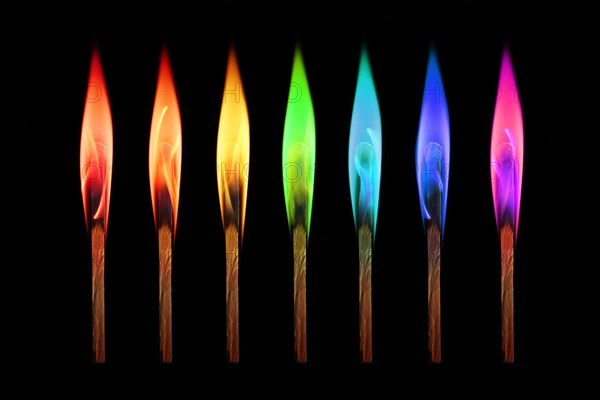 Matches burning in the rainbow colors flames on black background