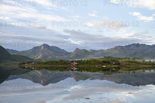 Mountains reflected in fjord near Laukvik