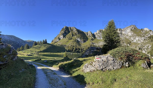 Hiking trail marking on a stone at Seebergsee
