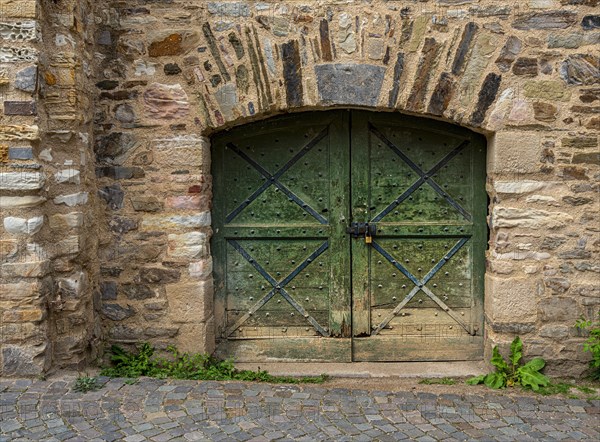 Massive wooden gate on the cellar vault of a castle