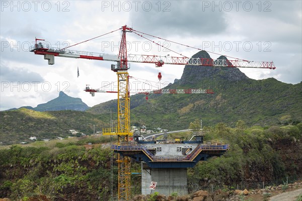 Construction site of bridge with crane across the Grand River of North West near the city of Beau Bassin