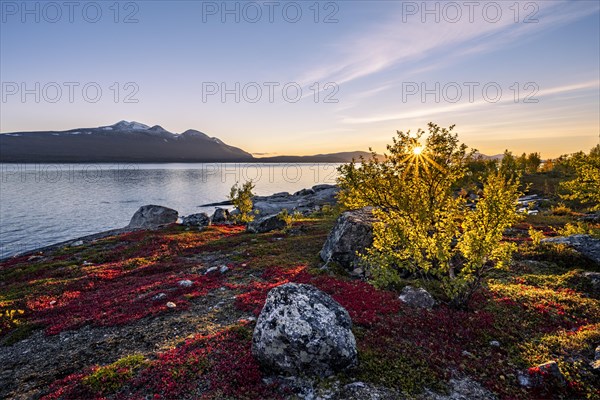 Autumnal fell landscape with lake Akkajaure and mountain range Akka