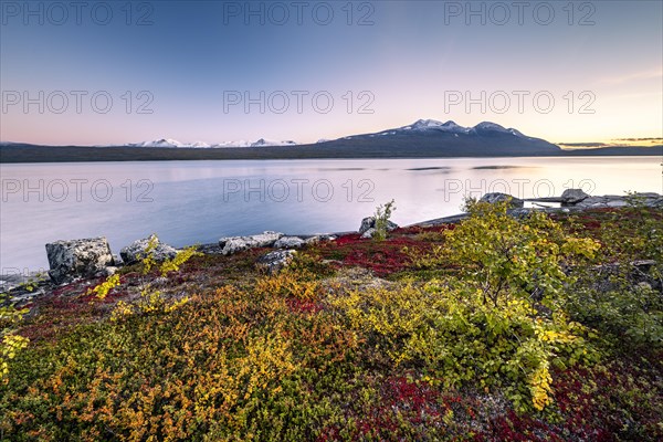 Autumnal fell landscape with lake Akkajaure and mountain range Akka