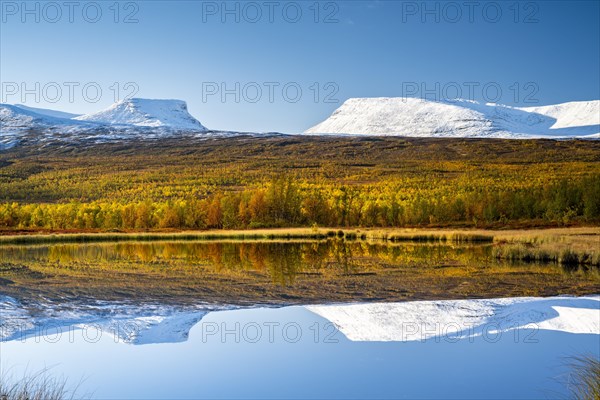 Mountain group Lapporten reflected in small pond