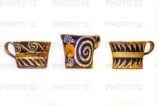 Cups decorated in white and polychrome Kamares style