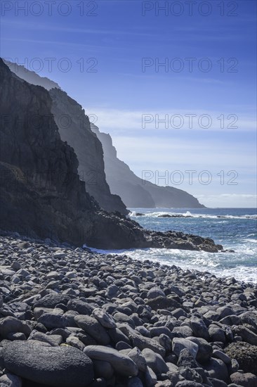 The beach framed by rocks at Playa del Trigo