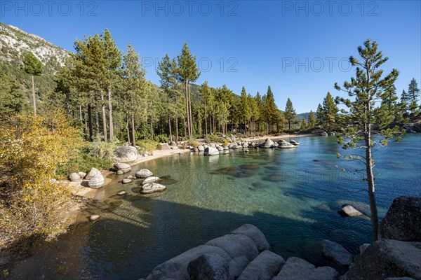 Sand beach and round stones in the water