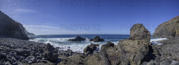 The beach framed by rocks at Playa del Trigo