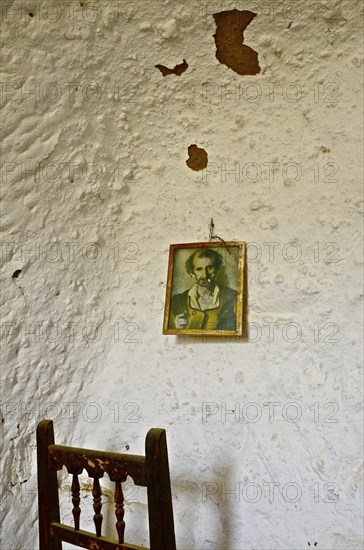 Picture on white wall with chair back
