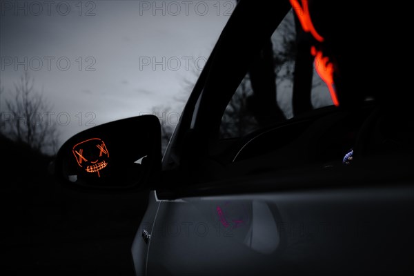 Man with Purge mask in car