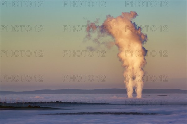Two columns of steam rising from cloud cover