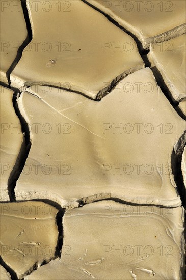 Dried clay soil with deep furrows
