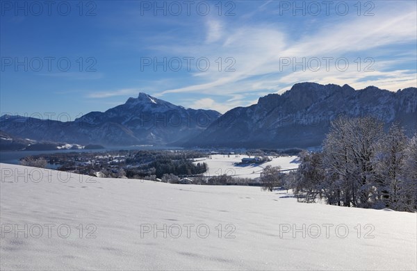 View of snow-covered Mondseeland with Schafberg and Drachenwand