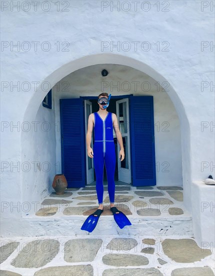 Young man in blue wetsuit with fins