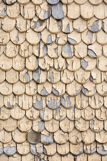 pattern of old wooden shingles with peeling paint