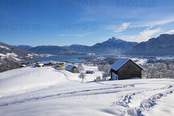 View of snow-covered Mondseeland with Schafberg and Drachenwand