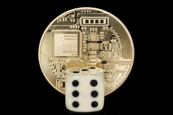 A dice in front of a coin