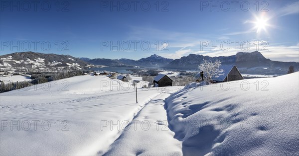 View of snow-covered Mondseeland with Schafberg and Drachenwand