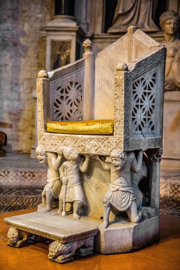 Bishop's chair resting on supporting figures with faces distorted by pain