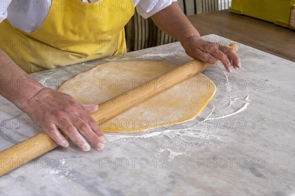 Woman rolling pasta dough