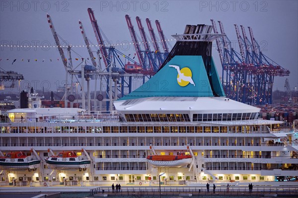Cruise ship Artania at Hamburg Cruise Center Altona with the cranes of the harbour in the background