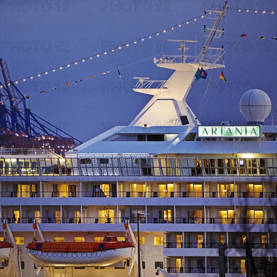 Cruise ship Artania at Hamburg Cruise Center Altona with the cranes of the harbour in the background
