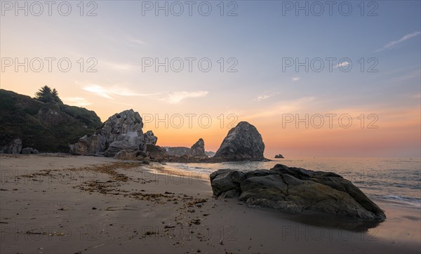 Sandy beach beach Harris Beach with rocks at sunrise