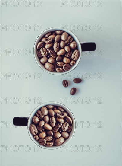 Coffee beans falling into a cup