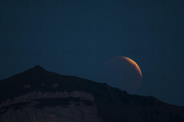 Lunar eclipse above the mountain station of Hohen Kasten
