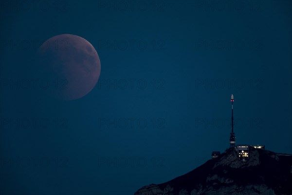 Lunar eclipse above the mountain station of Hohen Kasten