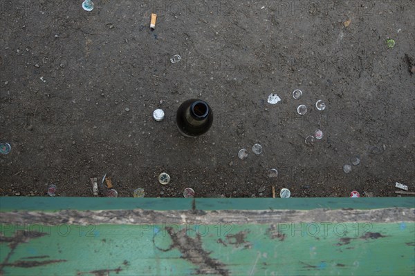 Empty beer bottle on a park bench at Heidelberger Platz