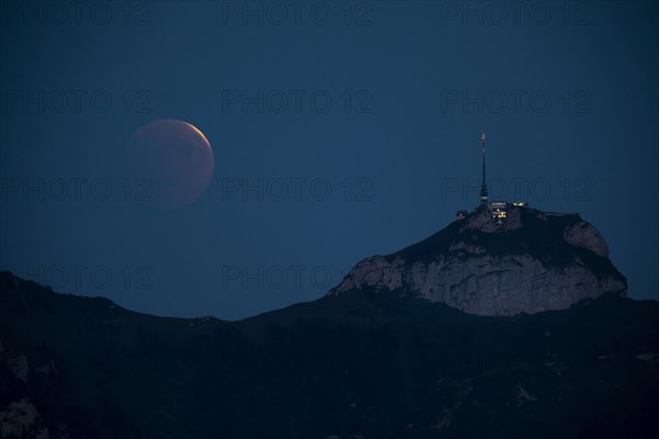 Lunar eclipse above the mountain station of Hohen Kasten