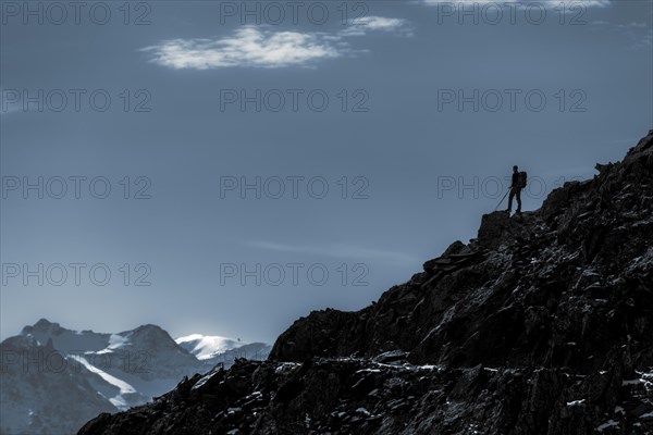 Mountaineers on mountain ridge in the background glaciated mountains