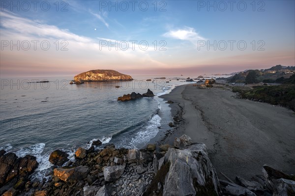 Sandy beach beach Harris Beach with rocks at sunrise